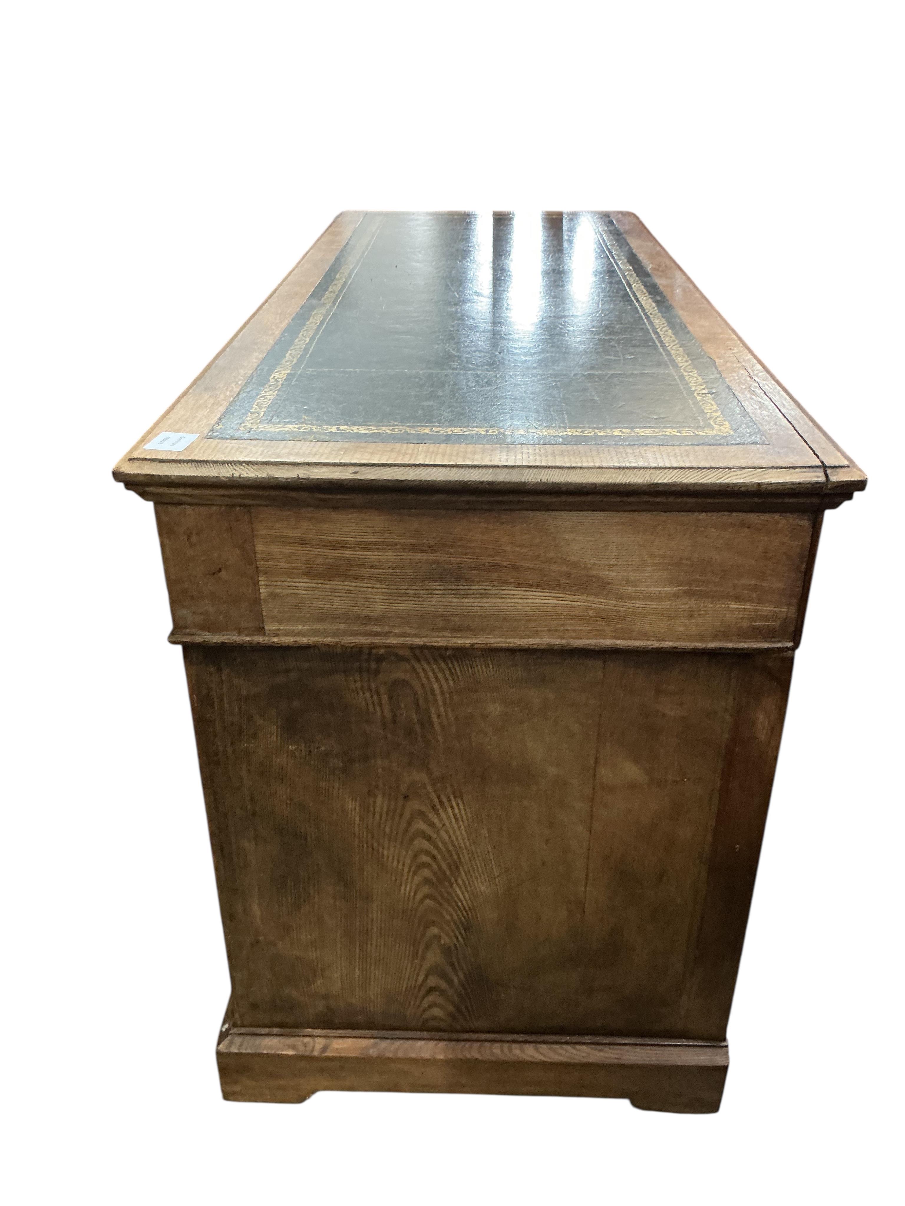 An early 20th century oak pedestal desk, width 138cm, depth 58cm, height 78cm